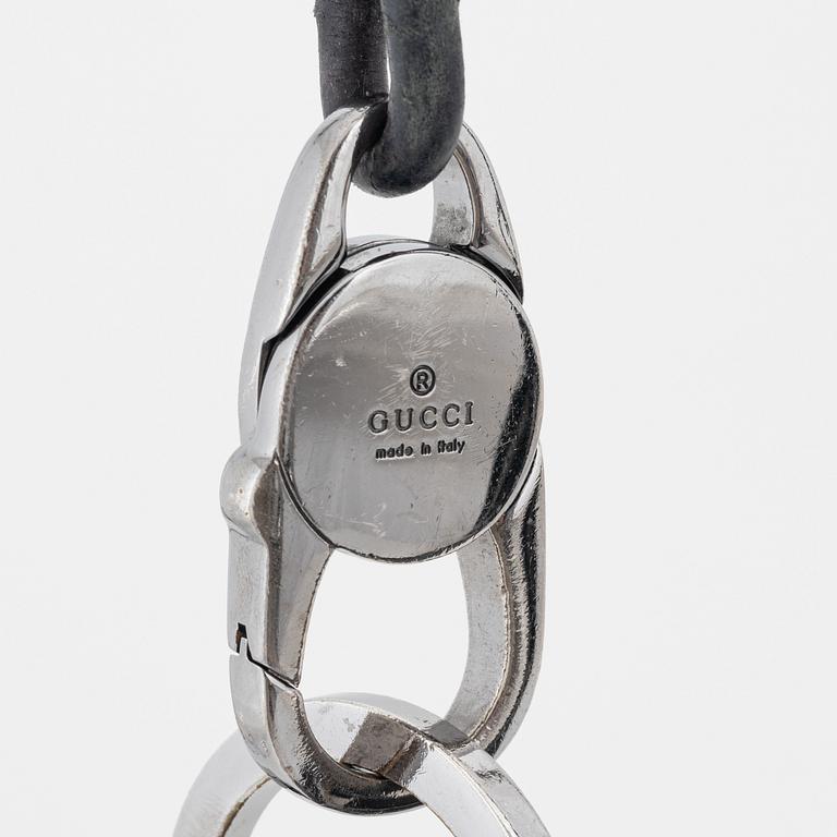 Gucci, a leather bag.