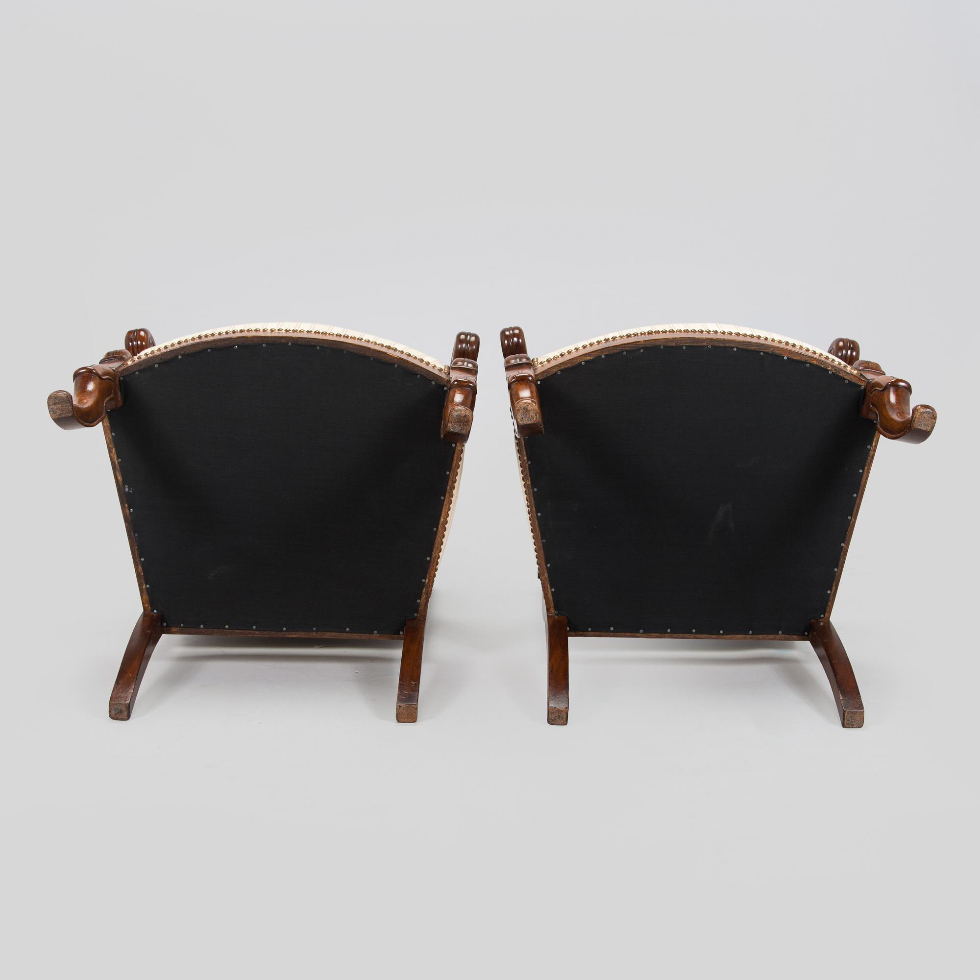 A pair of French open-arm chairs, first half of the 19th century.