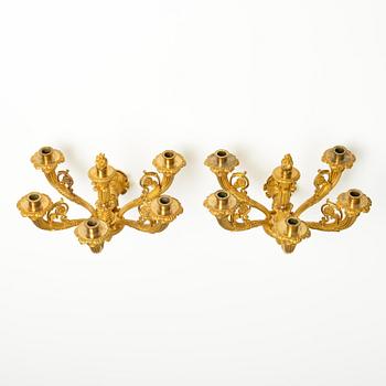 A pair of French Empire six-branch ormolu appliques, ca 1820's.