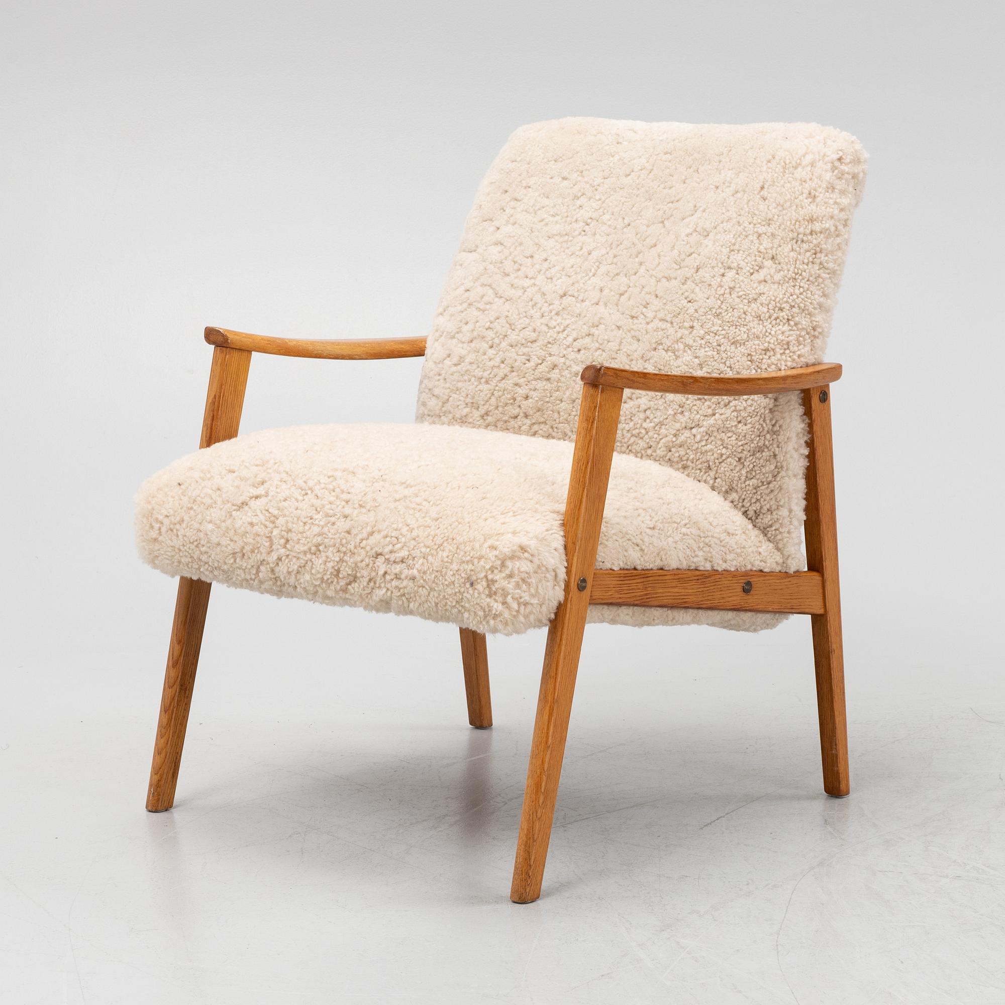 An oak easy chair with sheepskin upholstery. second part of the 20th Century.