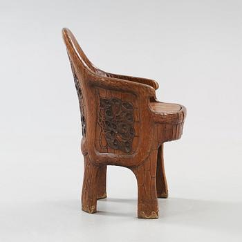 A Gustaf Fjaestad Art Nouveau carved pine chair 'Stabbestol', executed by Adolf Swanson, Arvika, Sweden 1908.
