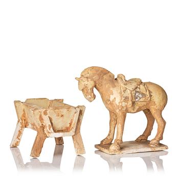 873. A pottery figure of a horse and a crib, Tang dynasty (608-918).