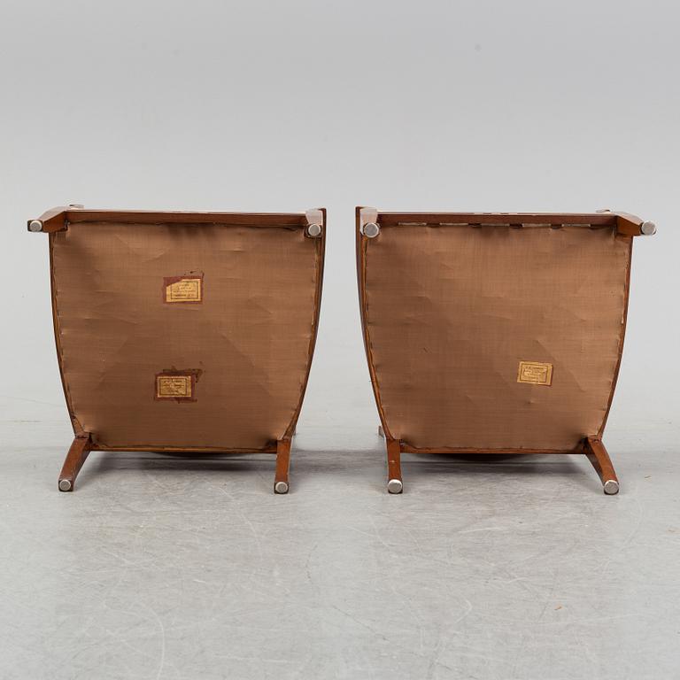 A mahogany sofa, with two armchairs and a round table, early 20th Century.