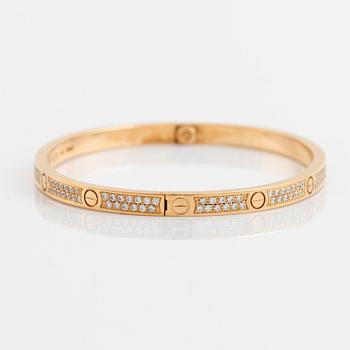 A Cartier "Love" bracelet small model in 18K gold set with round brilliant-cut diamonds.