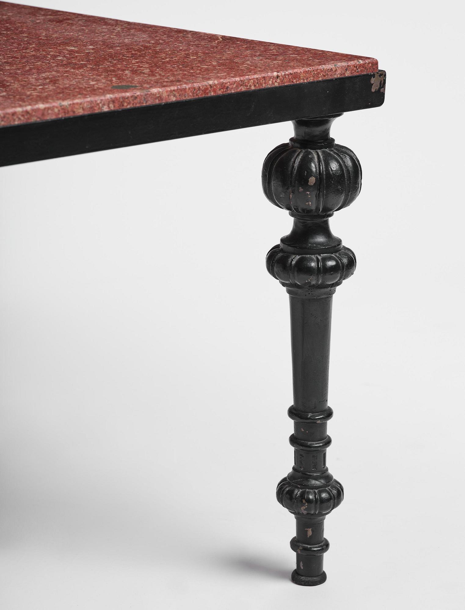 A table with granite stone top from Älvdalen, first part 19th century on a later metal stand.