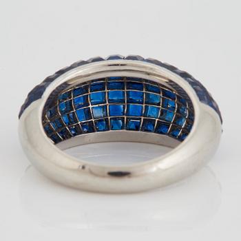 A platinum ring set with carre cut sapphires 6.28 cts according to engraving.