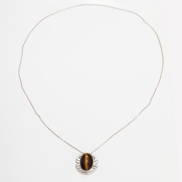 A silver ring and necklace with tiger's eye. Kultasepät Salovaara, Turku 1961.