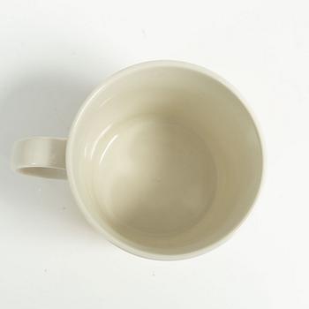 Muminmugg, "Mörk gul" med etikett, Arabia, Finland, 1991-99.