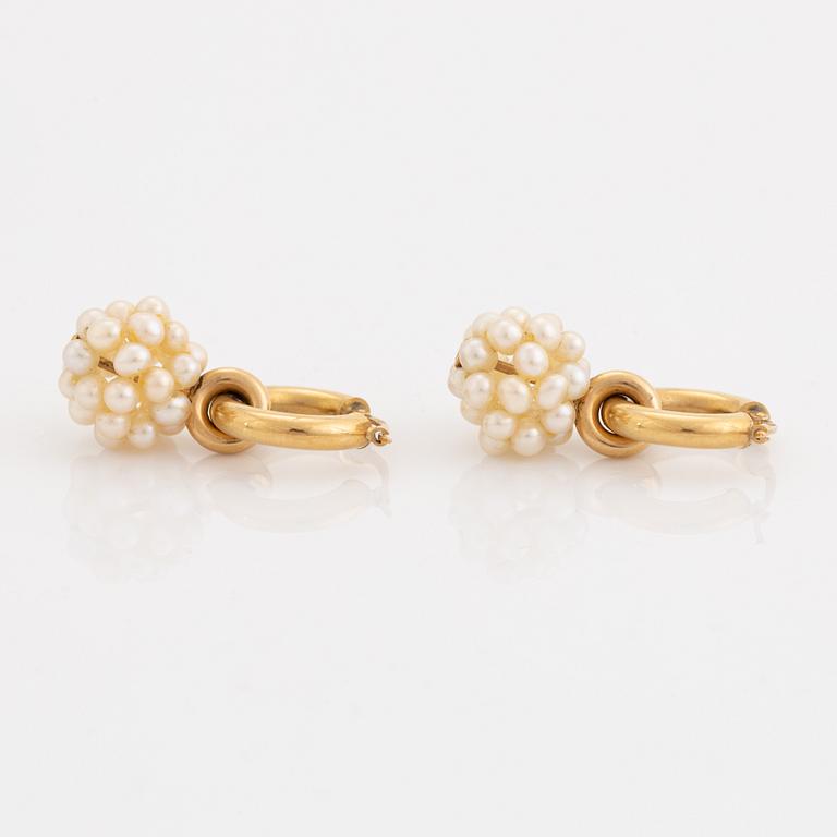 Pearl and gold earrings.