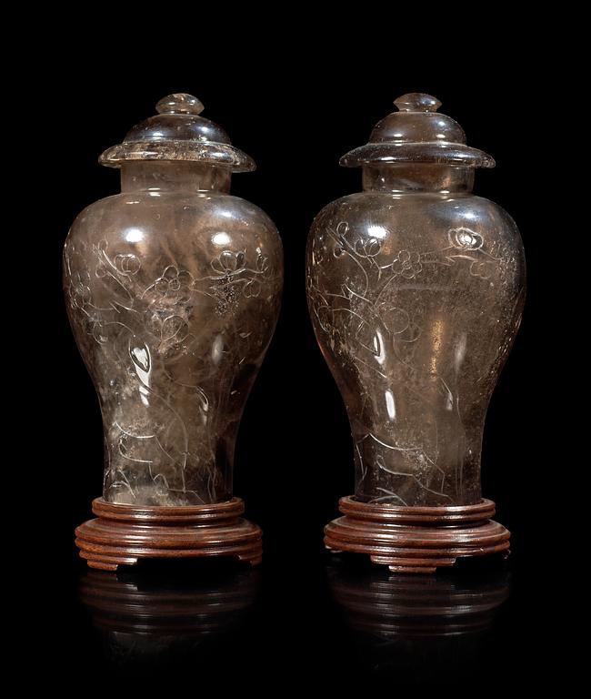 A pair of two rock kristal vases with covers, China early 20th Century.