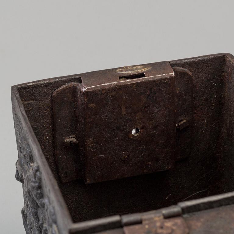 An empire cast iron tobacco box, dated 1838.