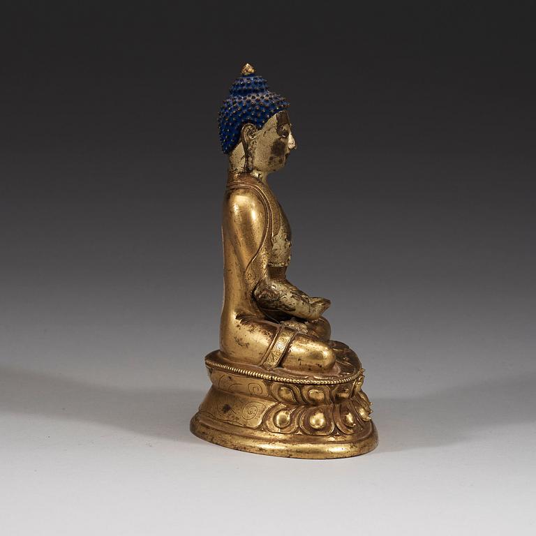 A seated Sino-Tibetan part gilt bronze figure of Amithaba Buddha, 18th Century.