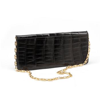 CÈLINE, a black croco clutch.