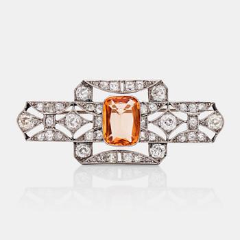 575. A circa 5.30 ct topaz and old-cut diamond brooch. Total carat weight of diamonds circa 2.00 cts.