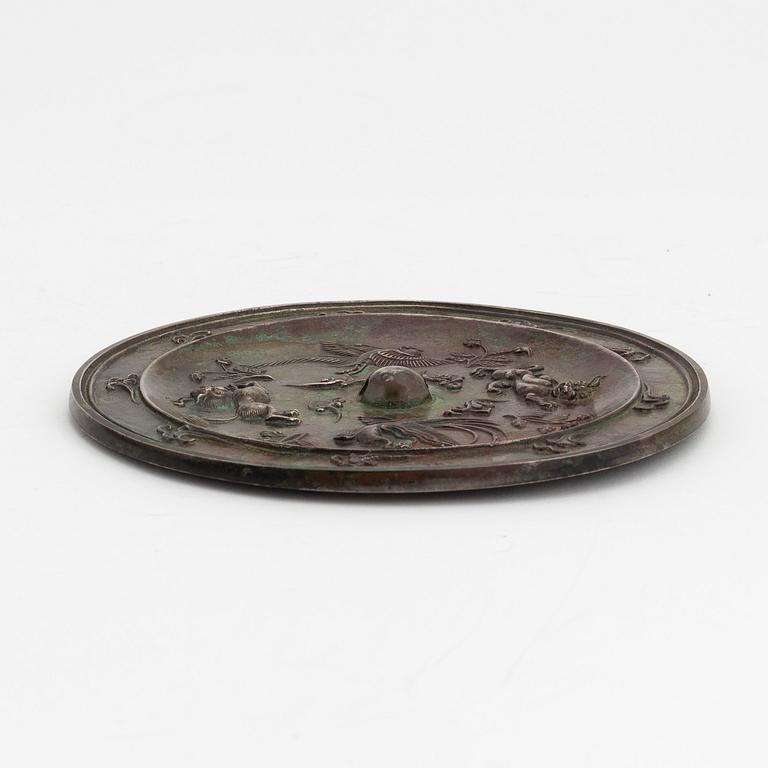A Chinese bronze mirror, presumably Ming dynasty (1368-1644).