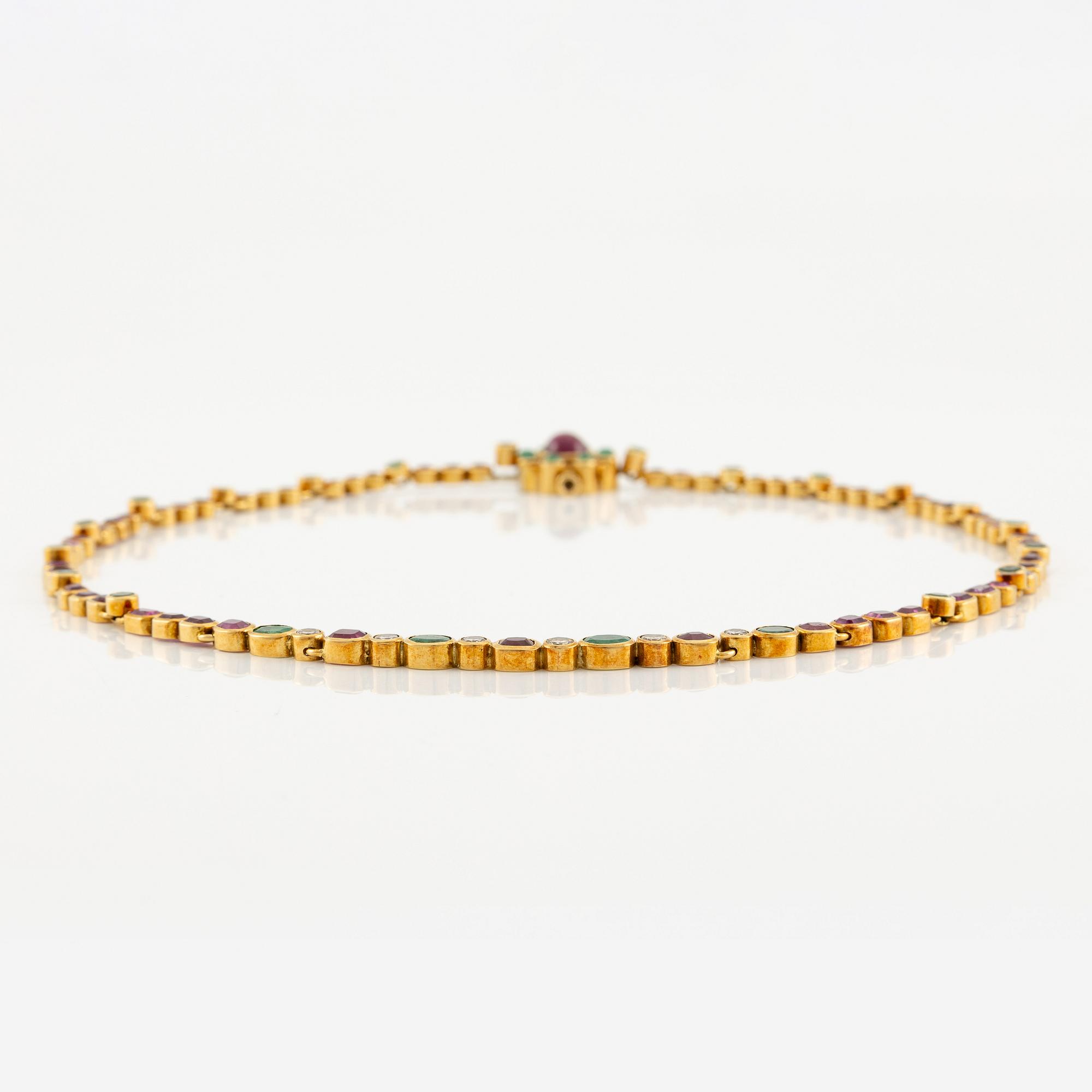 Andrew Grima, collier 18K guld med runda briljantslipade diamanter samt rubiner och smaragder.