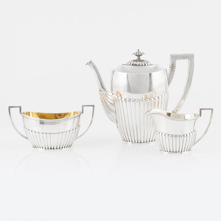 A Swedish silver coffee pot, creamer, and sugar bowl, mark of K Anderson, Stockholm 1903.