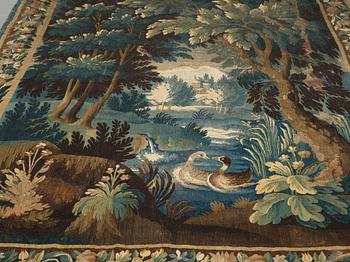 A TAPESTRY, tapestry weave, a "Verdure",  ca 304 x 224,5 cm, Flanders 17th century, signed "W" a lily "B".