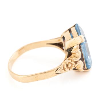 18K gold ring with a blue synthetic stone.