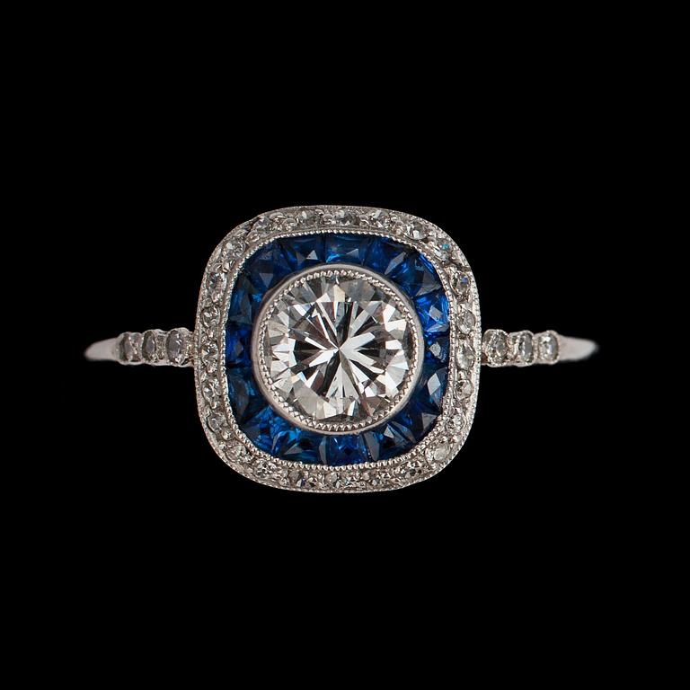 A brilliant cut diamond ring, tot. 0.77 cts set with small blue sapphires.