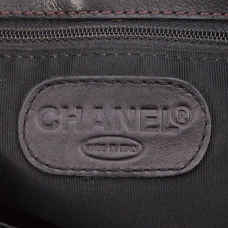 CHANEL, a black leather tote bag.