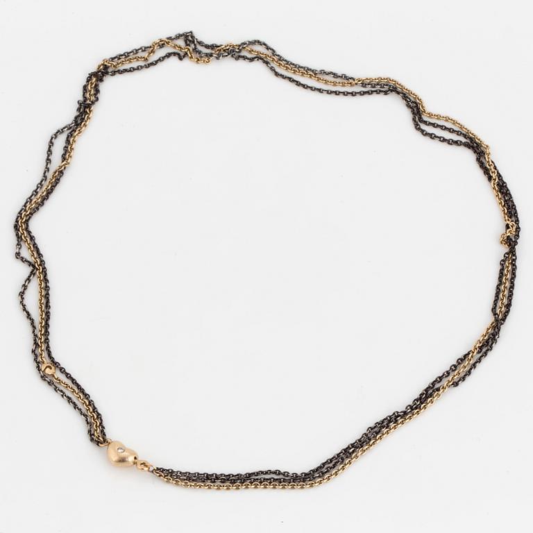 A necklace by Ole Lynggaard, the clasp decorated with a diamond.