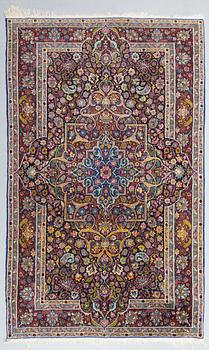 An oriental carpet. Circa 220x130 cm.