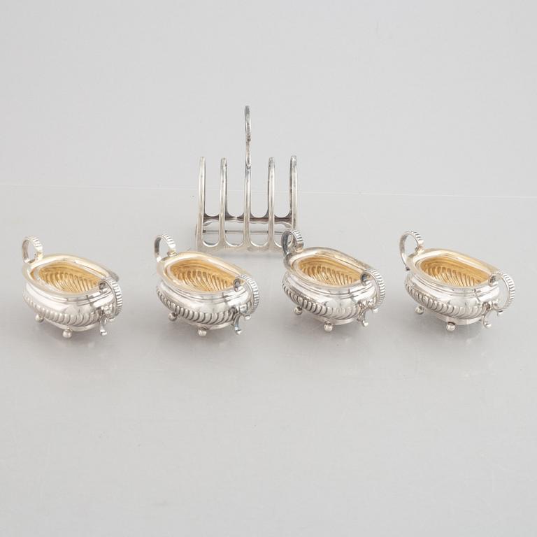 A set of four English silver salt cellars and a toast rack, including Roberts & Belk, Sheffield, England 1898.