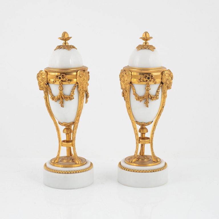 A pair of French Louis XVI-style ormolu and marble cassolettes, later part of the 19th century.