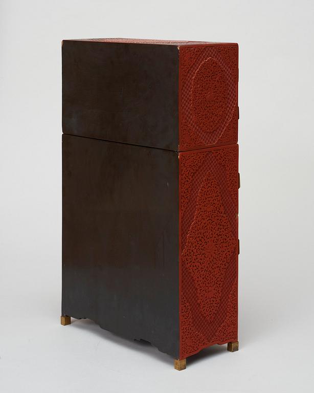 A well carved Cinnaber lacquer 'Kang'Cabinet, Qing dynasty, 18/19th Century.