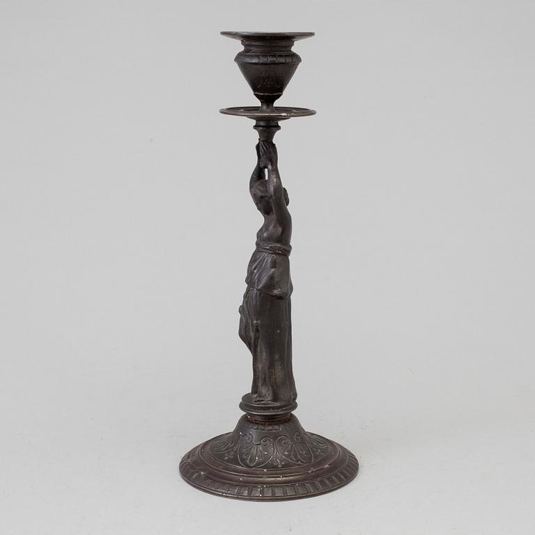 A 19th century iron candlestick marked F.L Vombach Offenbach A/M.
