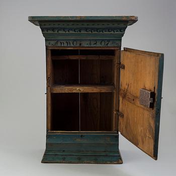 a oainted swedish wood wall cabinet, dated 1807.