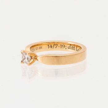 An 18K gold solitaire ring "Maui" set with a princess-cut diamond by Schalins.