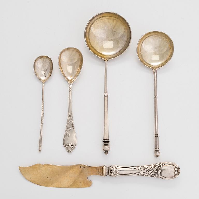 A silver butter knife by Grachev, and four spoons, St. Petersburg, Moscow, and one with Latvian import mark.