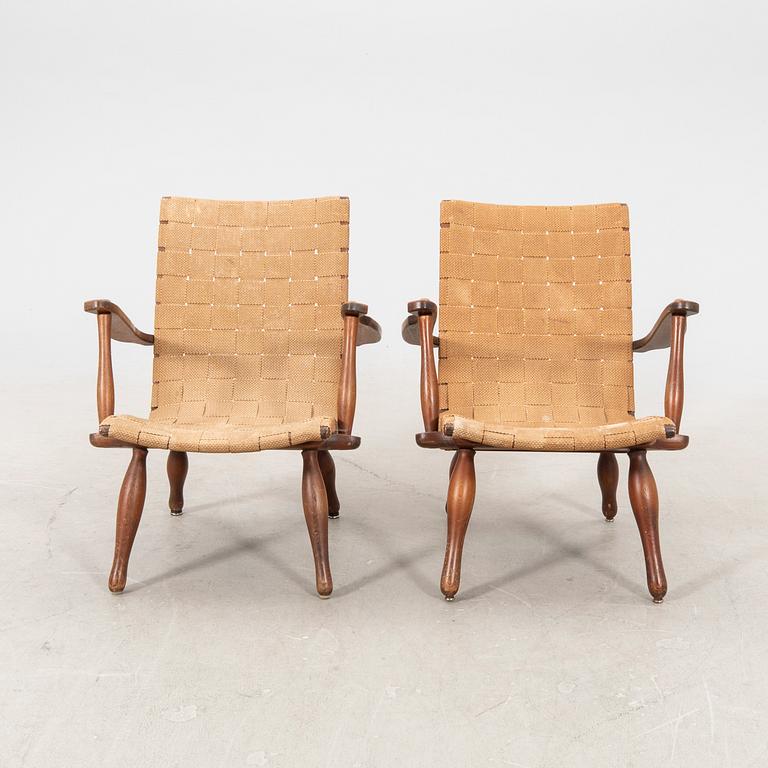 A pair of Swedish Modern pine and saddle-girth easy chairs from the 1940's.