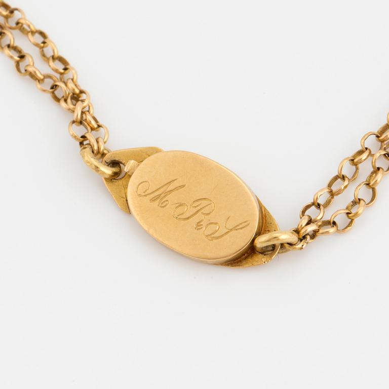 A chain and locket with hairwork.