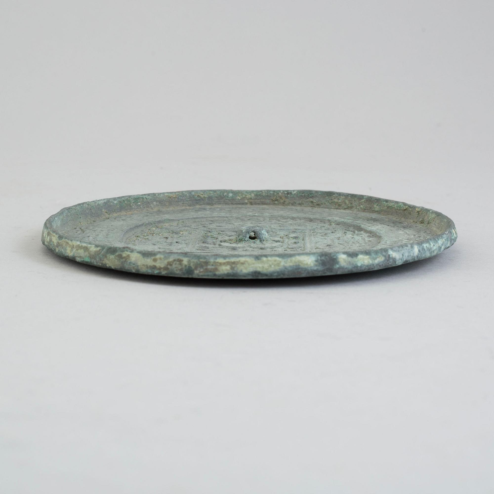 A bronze mirror, Xin-Eastern Han dynasty (9-220).