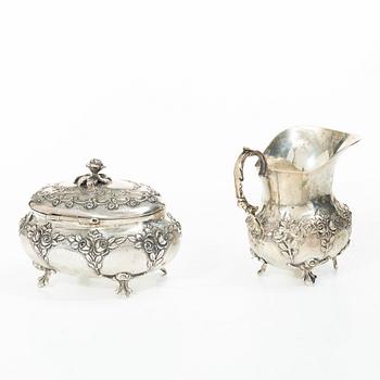 A silver sugar bowl, creamer and sugar tongs, 20th century.