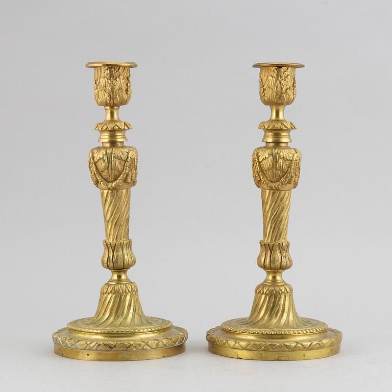 A pair of bronze Louis XV-style candlesticks, circa 1900.