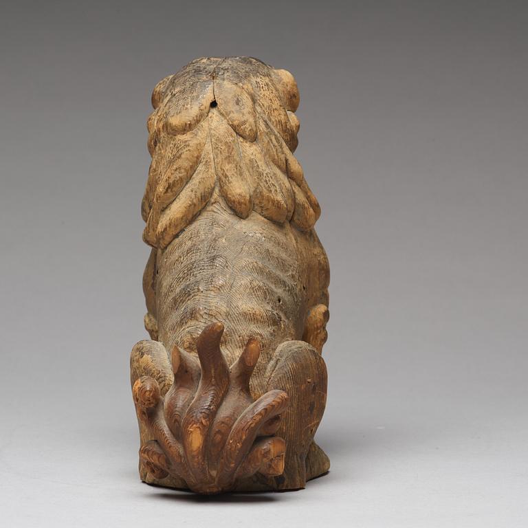 A wooden sculpture of a buddhist lion, Qing dynasty, 19th Century.