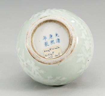 A slip decorated celadon bowl, Qing dynasty, 19th Century, with Kangxis six character mark.