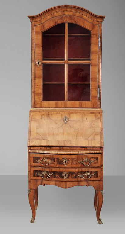 A Rococo walnut writing cupboard.