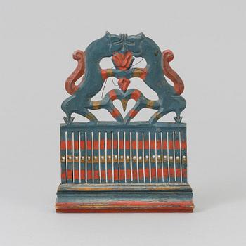 a painted wooden loom from the 19th century.