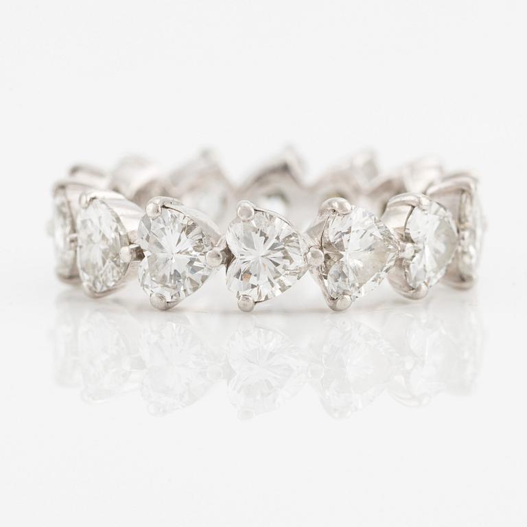 A Graff platinum eternity band set with heart shaped diamonds.