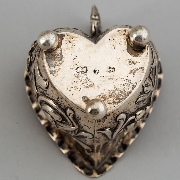 A small silver Baroque style  heart-shaped jug on ball feet.