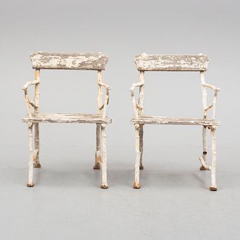 a pair of early 20th century garden cast iron chairs.