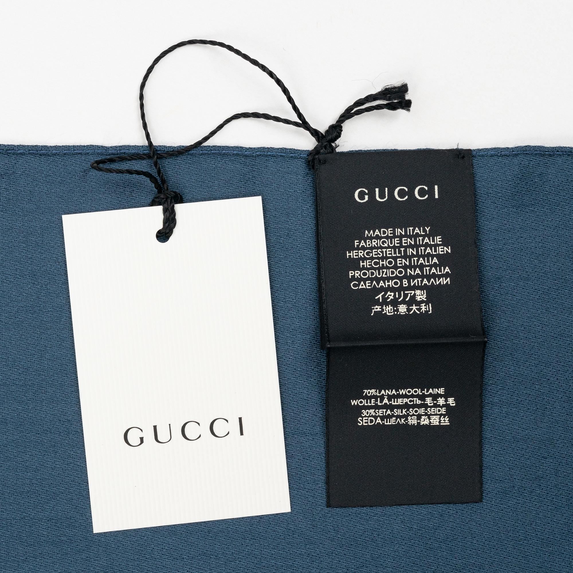 Gucci, a wool and silk mix "GG" jaquard shawl.