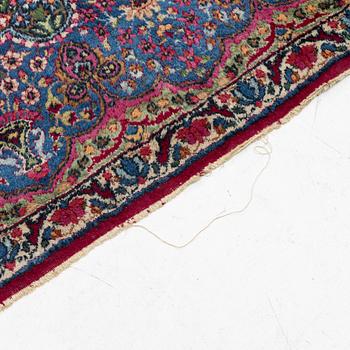 A Kerman carpet, c. 365 x 265 cm.