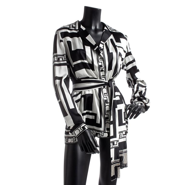 EMILIO PUCCI, a silk shirt with belt.