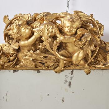 A presumably Dutch Louis XIV carved giltwood frame with mirror glass, in the style of Jean Le Pautre, late 17th century.